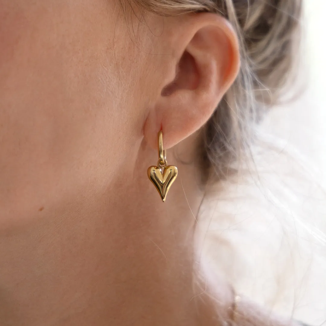 Gold coloured hoop earrings with a heart charm